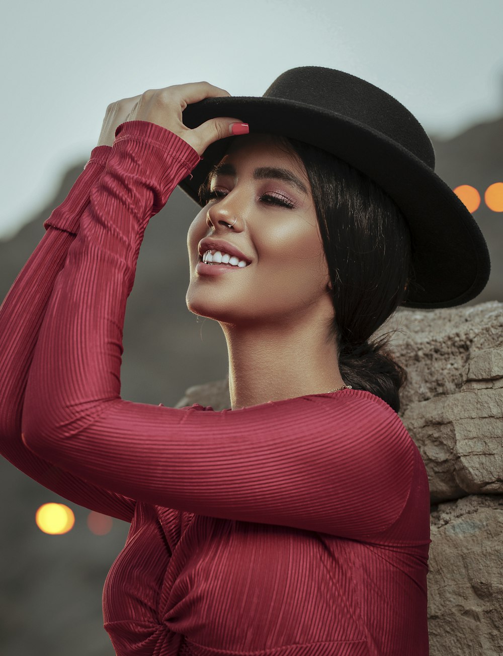 smiling woman wearing red long-sleeved shirt