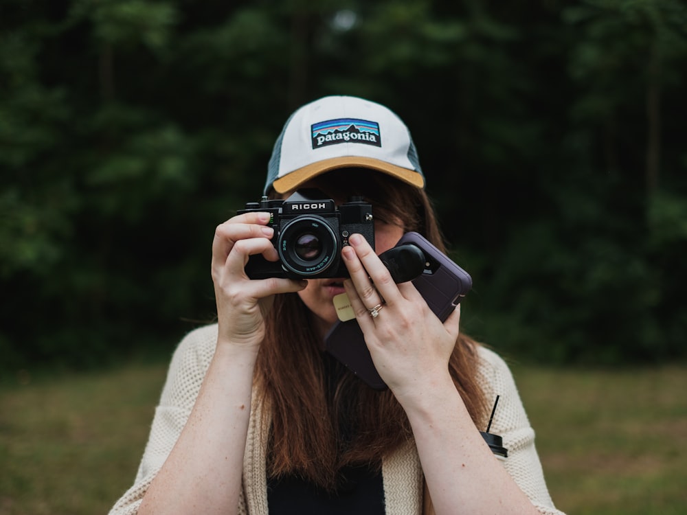 woman about to take a photo using black bridge camera