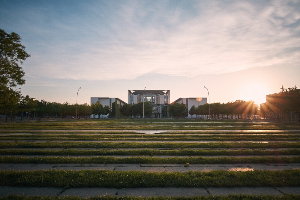 the sun is setting over a park with steps