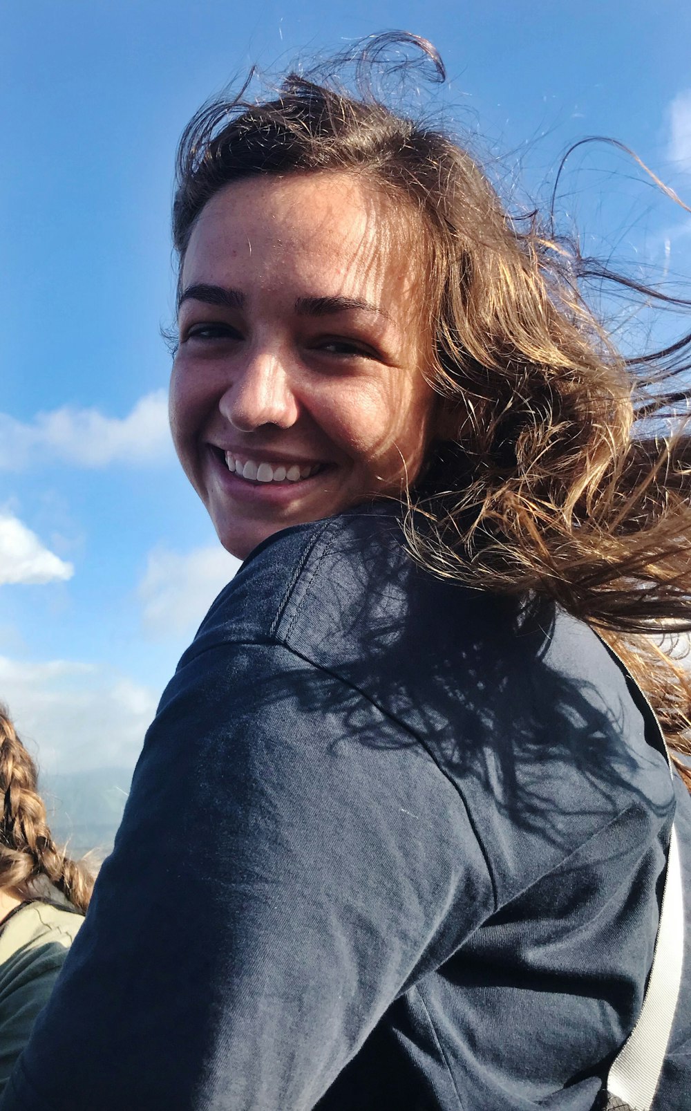 smiling woman wearing blue long-sleeved shirt