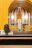 A warm photo of a smiling woman sitting peacefully inside a sunlit church pew.