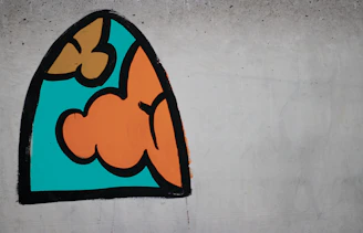 Colorful mural featuring abstract shapes and flowing lines on a city wall