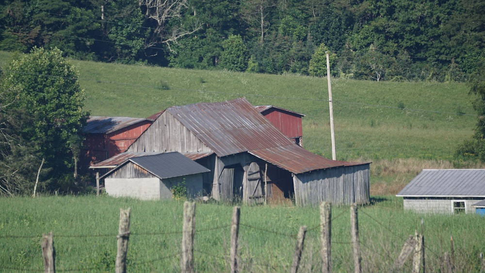 gray wooden barn with gray wooden wire fence