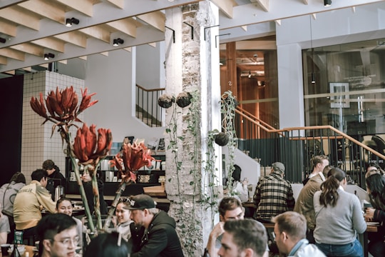 A bustling cafe scene with sleek tables and comfortable chairs arranged for socializing.