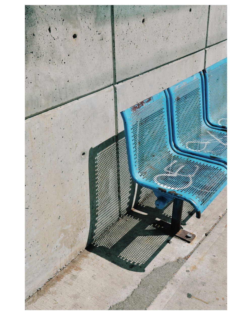 blue steel bench close-up photography