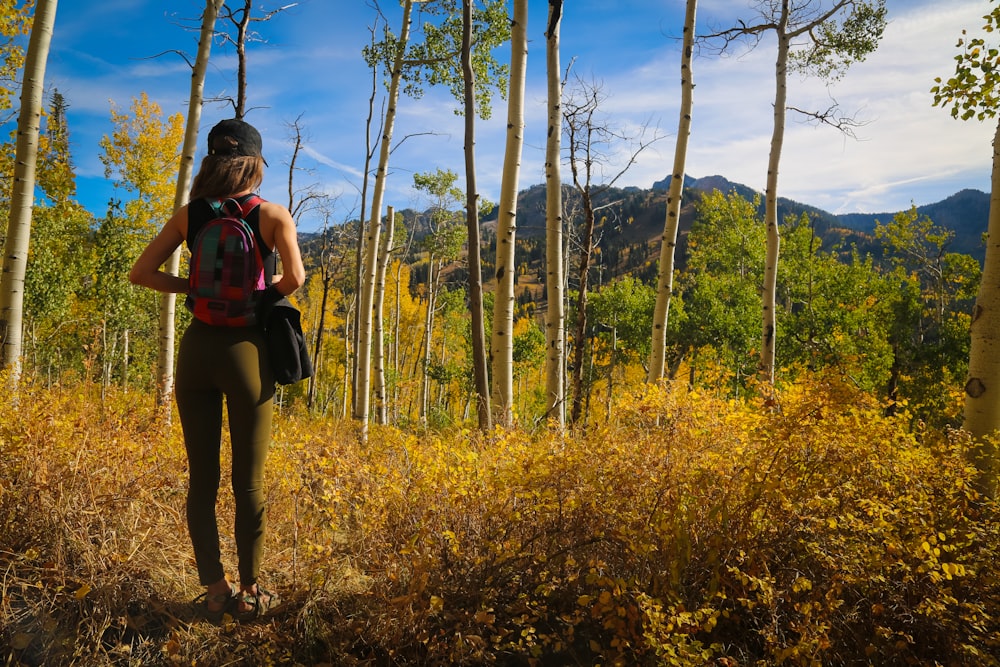 women wearing green leggings near trees during daytime