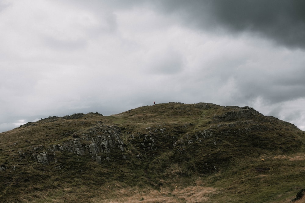 green mountain under cloudy sky during daytime