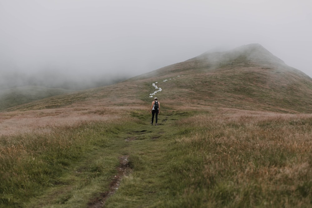 woman in the middle of the mountain