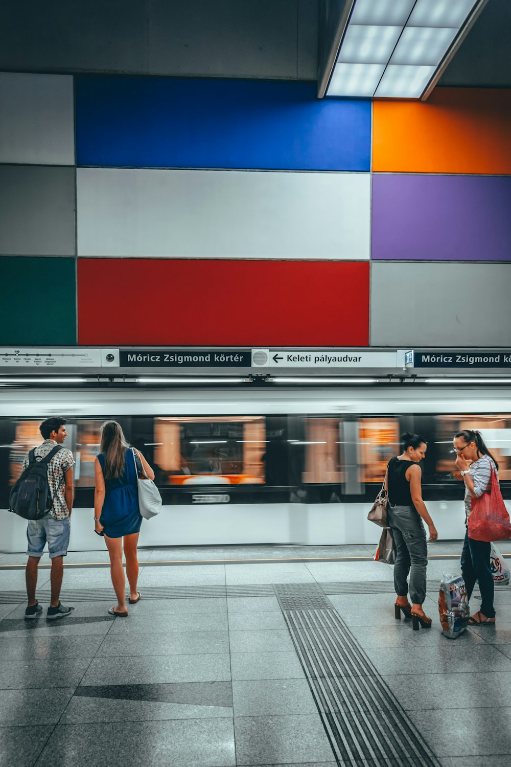 people standing near train station