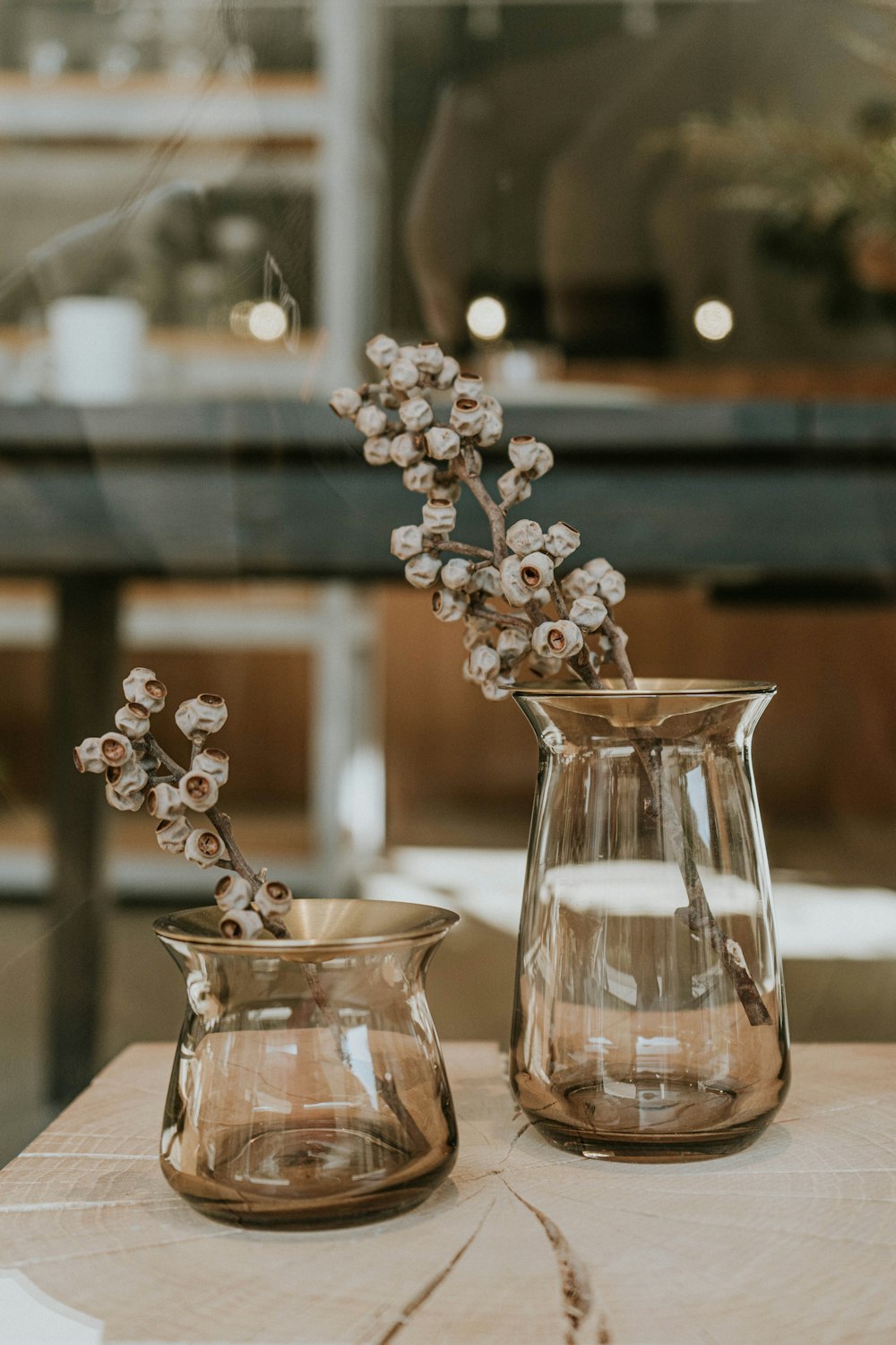 two clear glass vases with white flowers