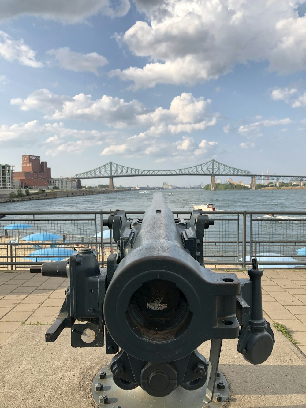 grey steel canon near body of water during daytime
