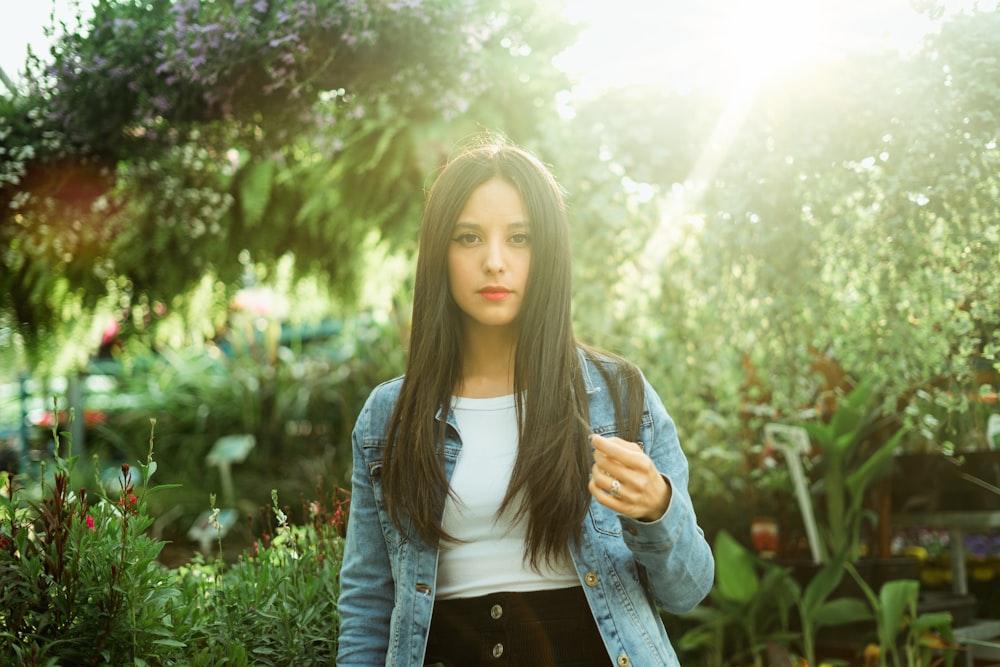 woman standing near green-leafed plant