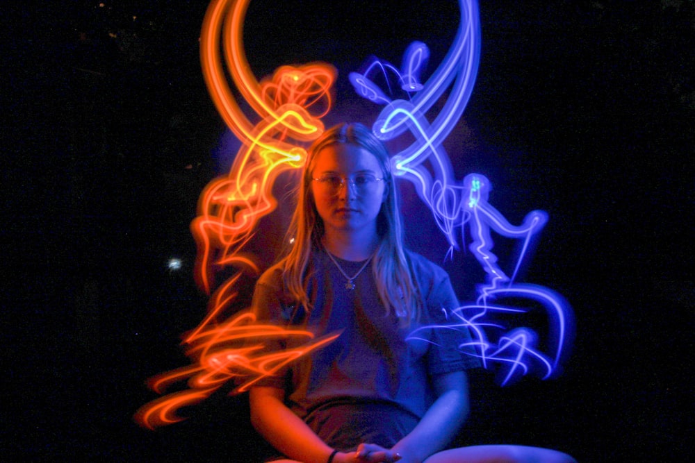 woman surrounded by blue and orange lights