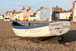 white and blue boat on sea shore