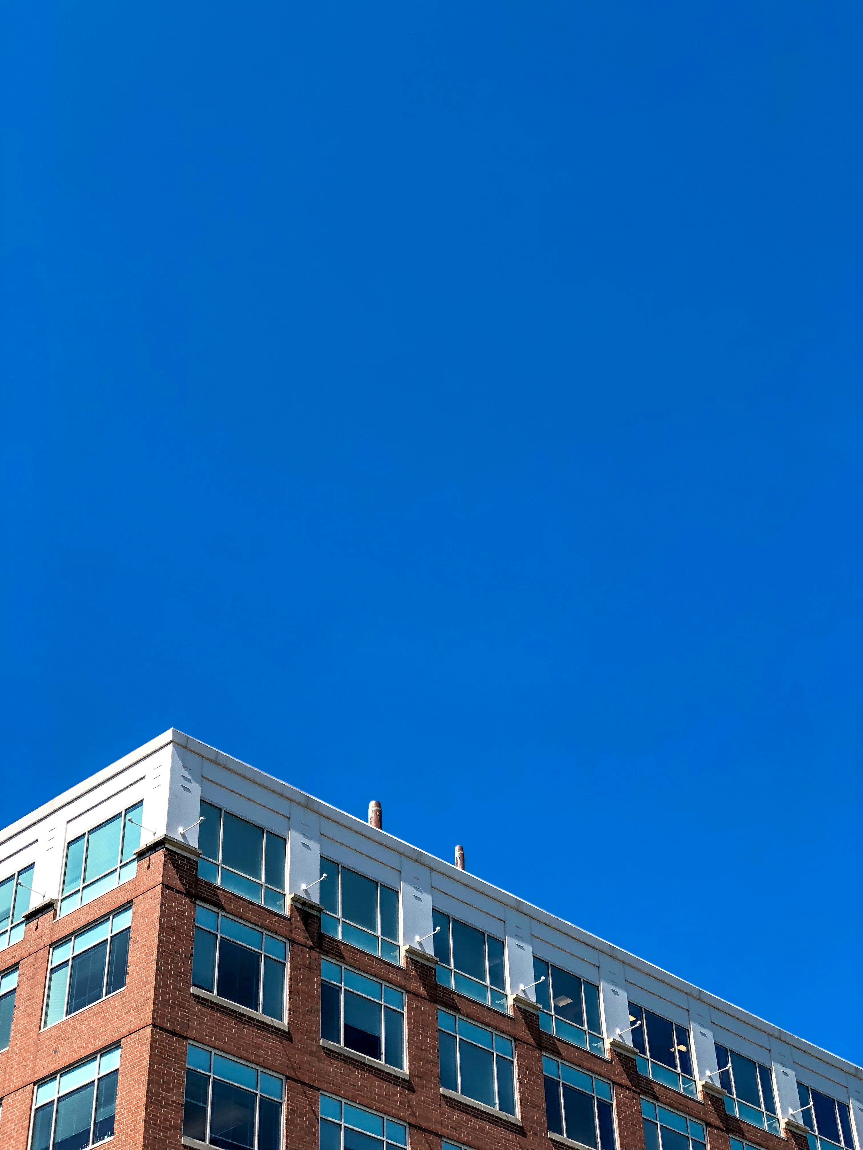 white and brown building under clear blue sky