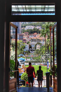 Close-up of happy couple holding keys in front of a luxury apartment entrance.