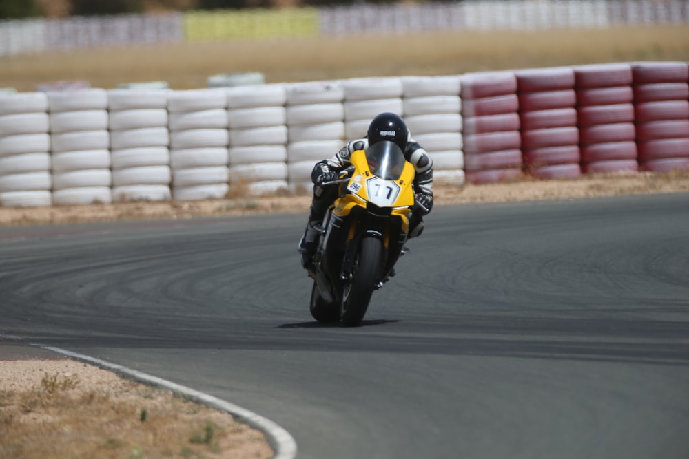 man on yellow superbike in race track