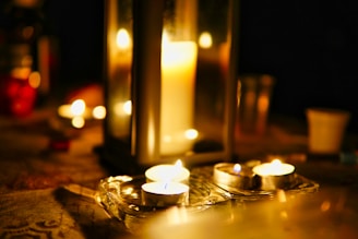 An inviting scene of candles lit, casting a warm glow in a cozy room.