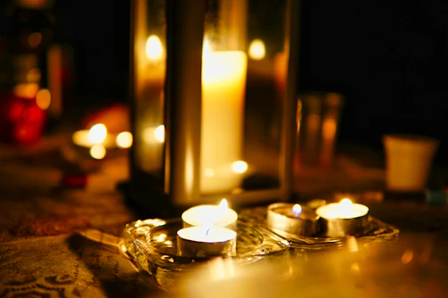 A serene living room scene with a lit candesso candle adding a cozy, sophisticated ambiance.