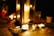 A serene living room with softly glowing candles on a coffee table, surrounded by cozy decor.