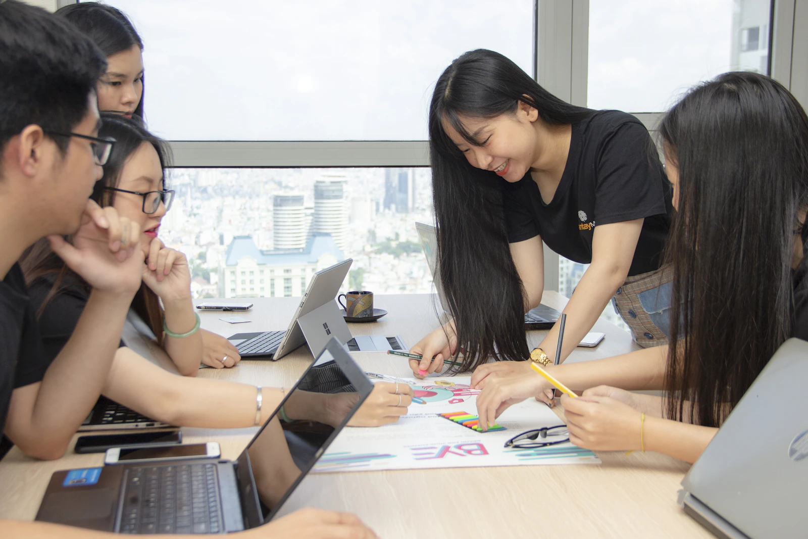 Two women working together at laptops