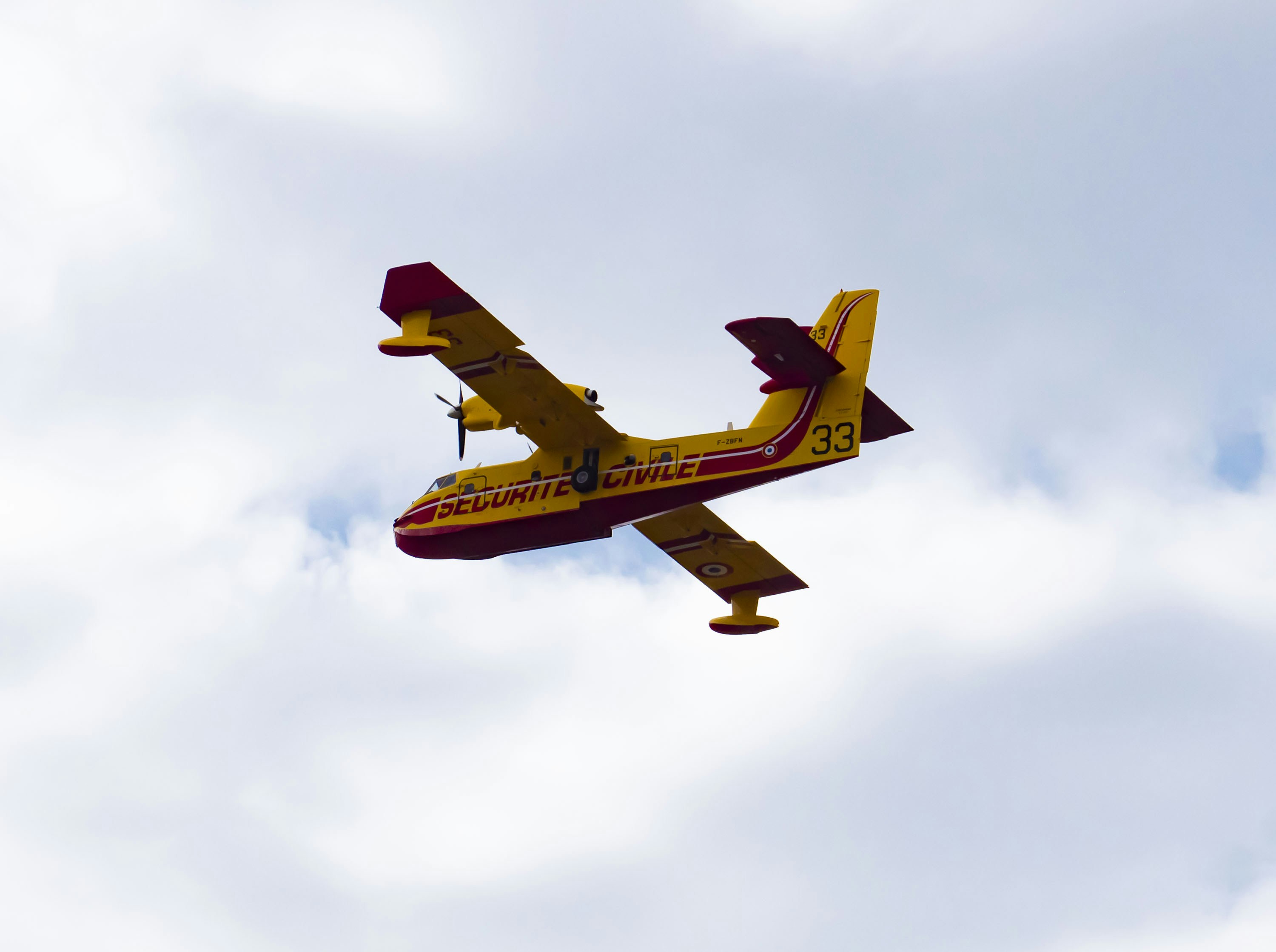 yellow airplane under clouded sky, Canadair au dessus de Propriano, Corse-du-Sud, France