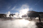A panoramic view of the Krafla geothermal power plant with steam rising against a clear sky.