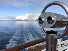 Majestic glaciers and snow-capped mountains viewed from the deck of an Alaskan cruise ship.