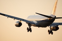blue and white plane flying during daytime