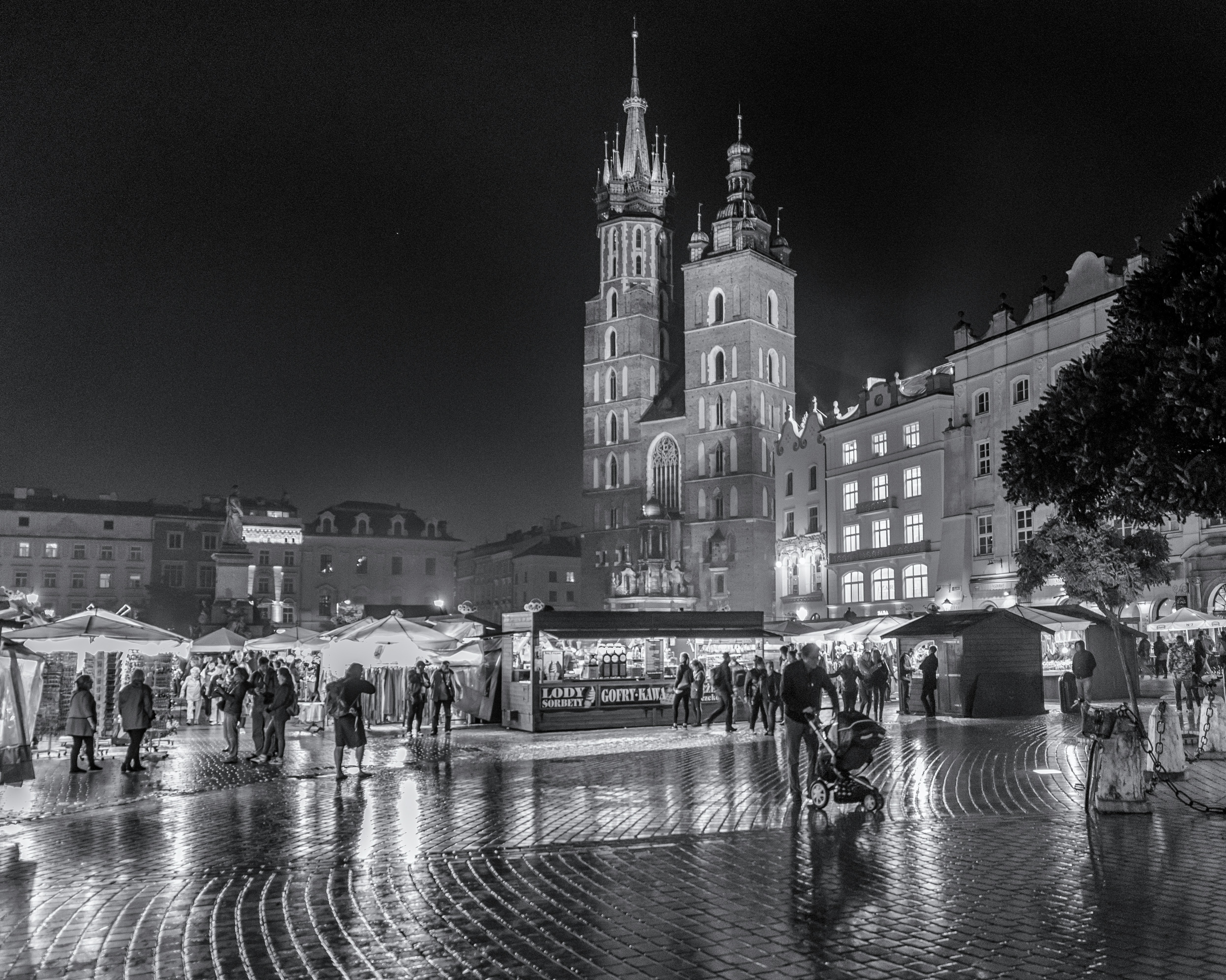 greyscale photography of people walking near concrete building