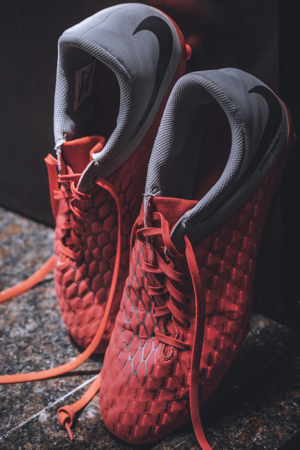 pair of grey and red shoes close-up photography