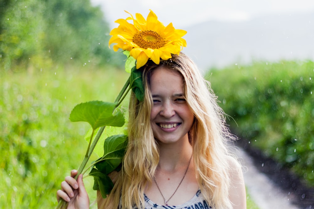 woman holding yellow sunflower
