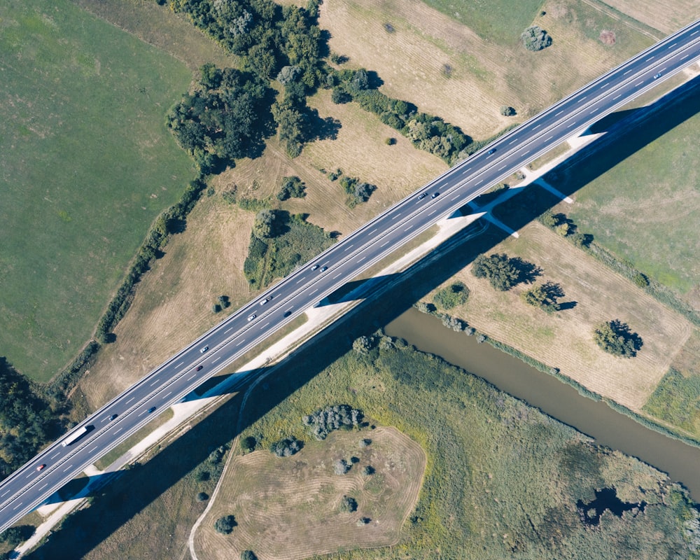 an aerial view of a highway crossing over a field