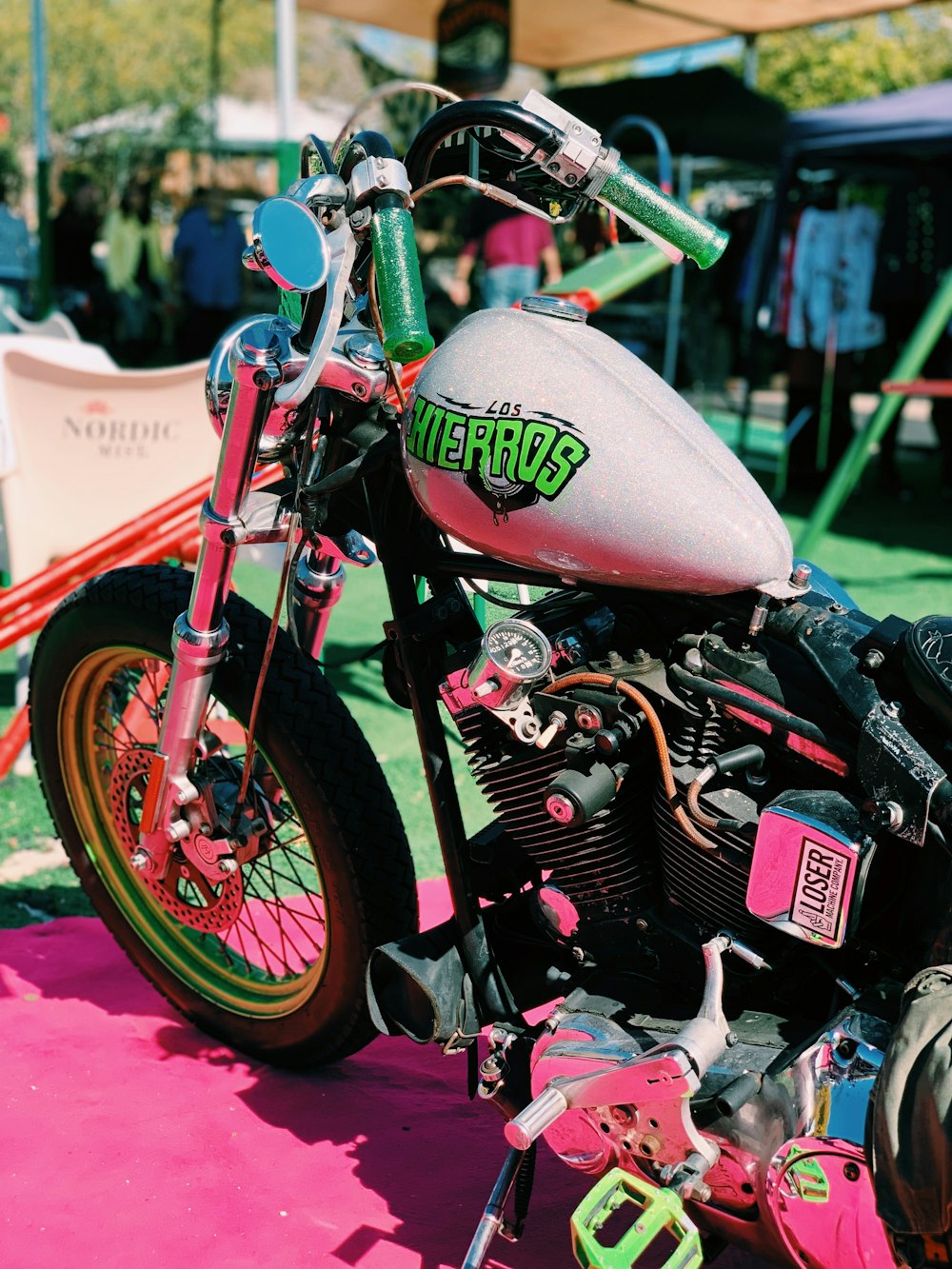 pink motorcycle parked near canopy tent