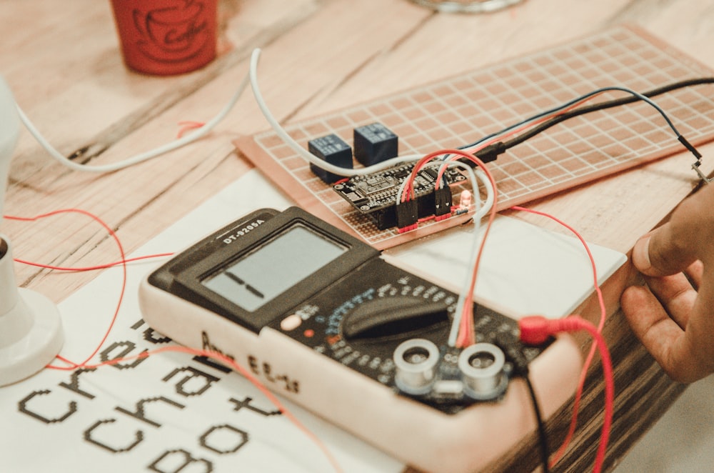 person uses white multimeter