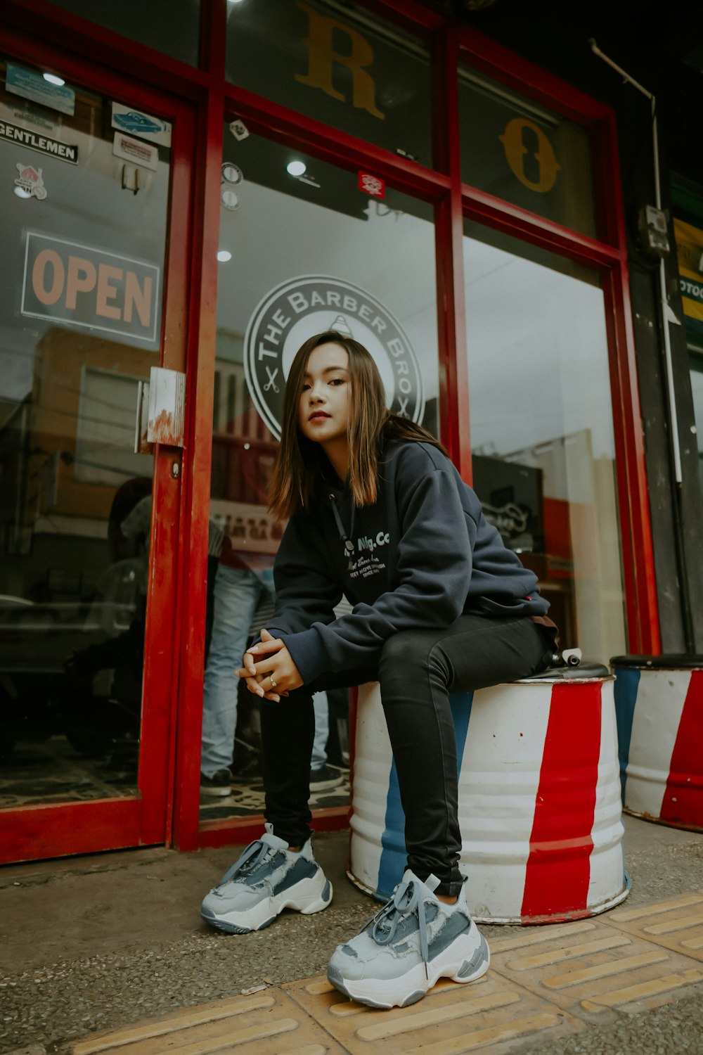 woman sitting in front of store door