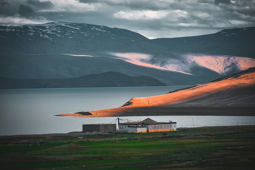 white concrete house near body of water