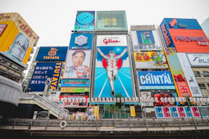 A bustling Osaka street scene featuring a mix of traditional and contemporary architecture.