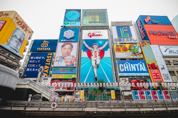 A group walking through the vibrant streets of Osaka with a guide pointing out hidden gems.