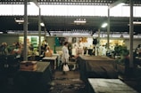 A busy marketplace with customers browsing various discounted products.