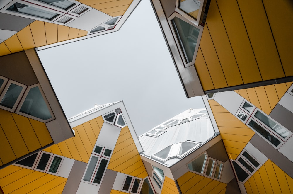 low-angle photography of yellow and white high-rise buildings