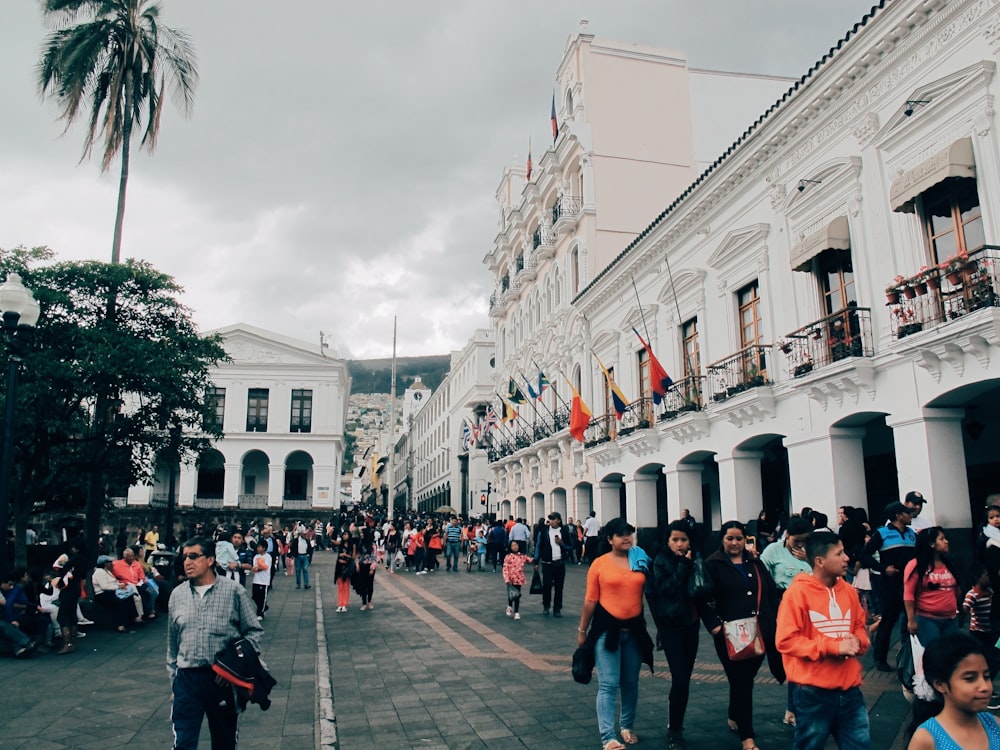 people walking beside building at daytime