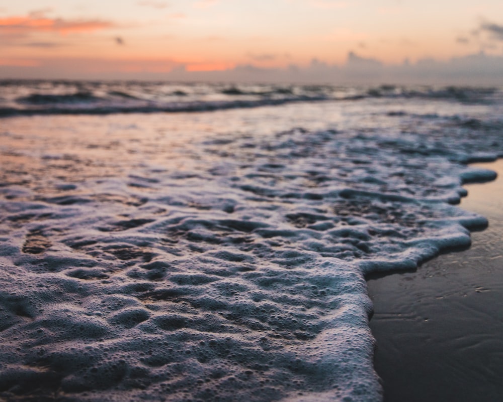 blue sea under orange sky