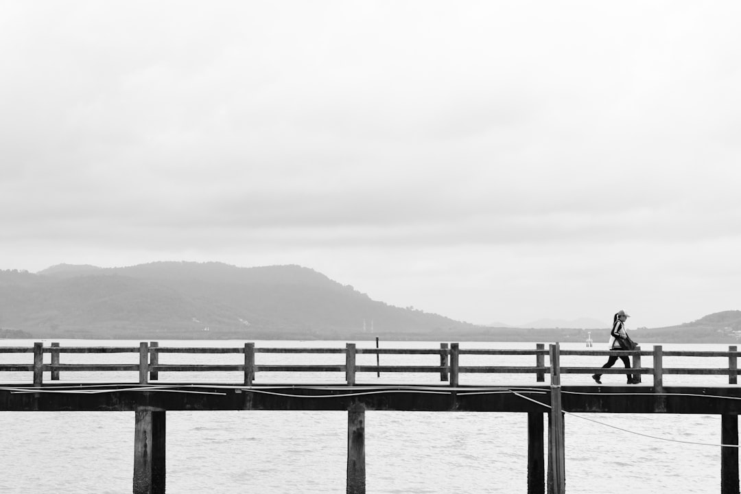 woman walking on sea dock