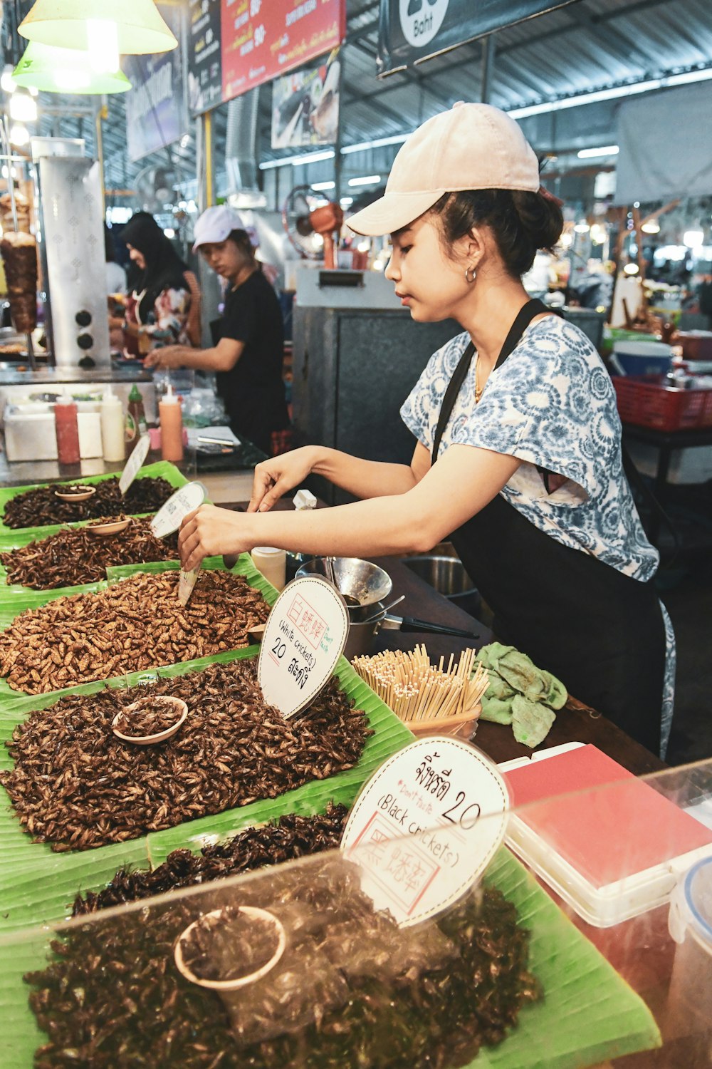 woman beside tray of foods