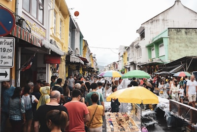 A bustling market street in a colorful foreign city filled with smiling locals.