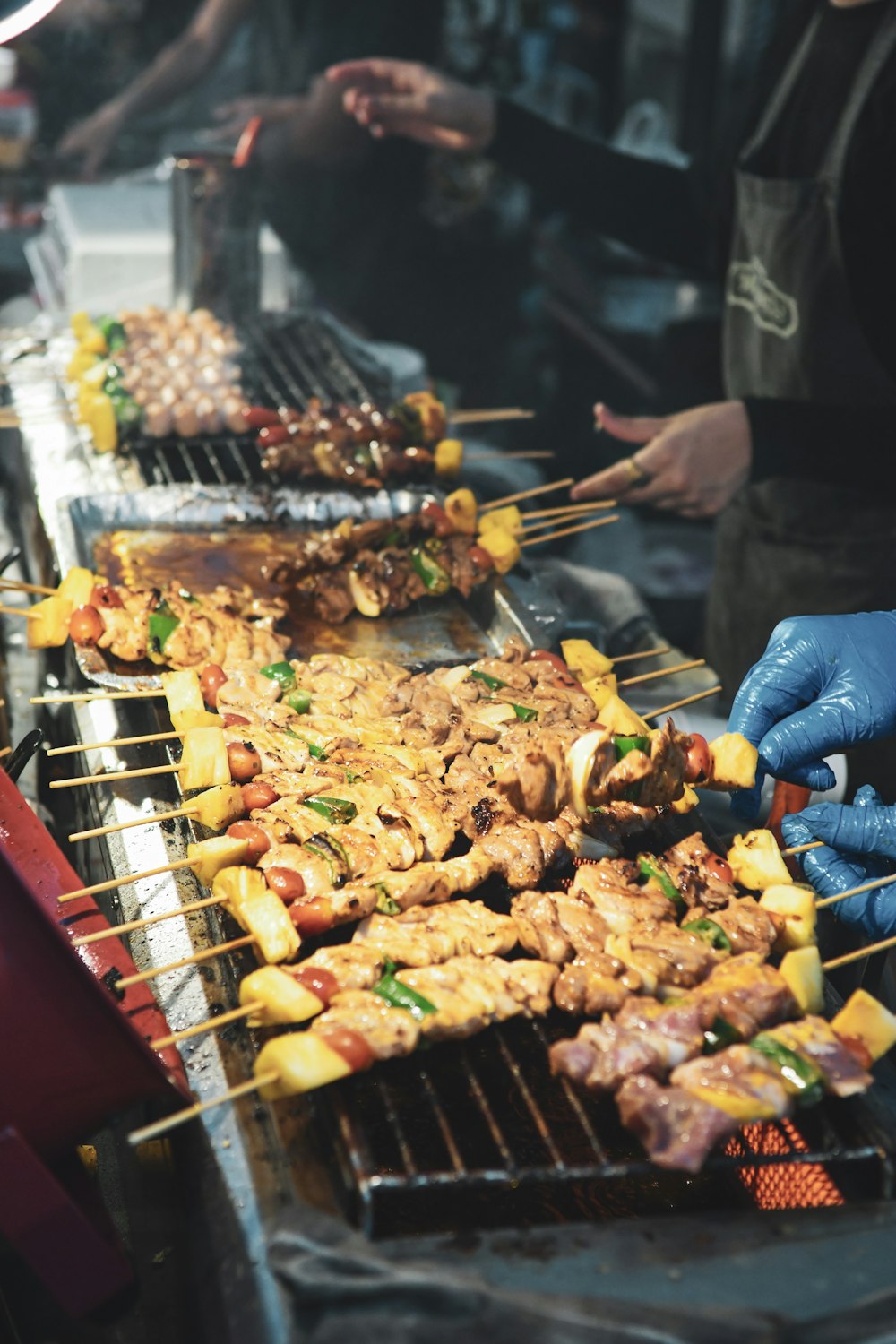 two person's cooking barbecue on street side