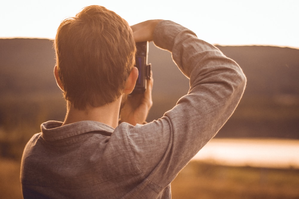 man taking pictures with DSLR camera