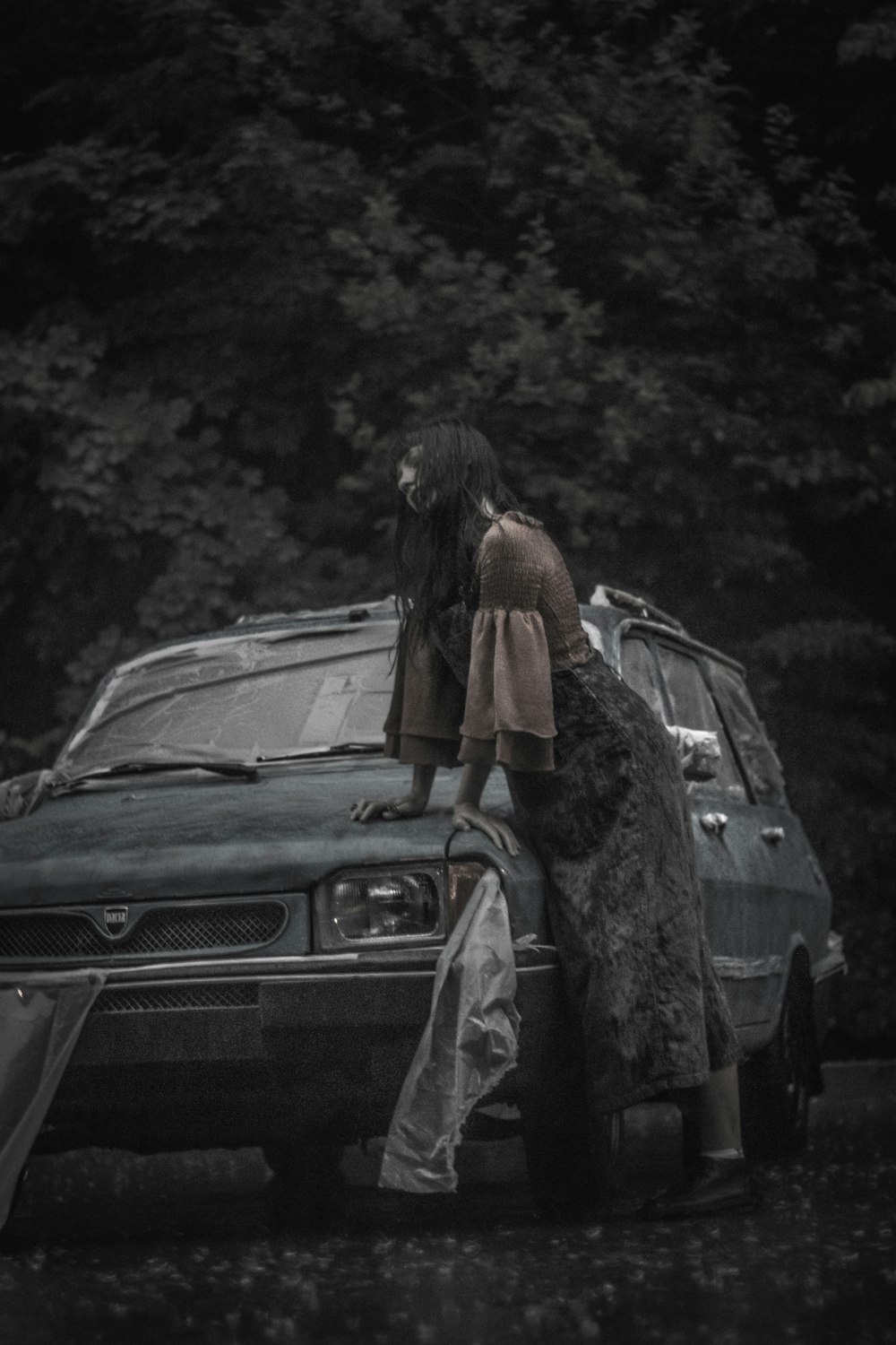 greyscale photography of woman beside vehicle