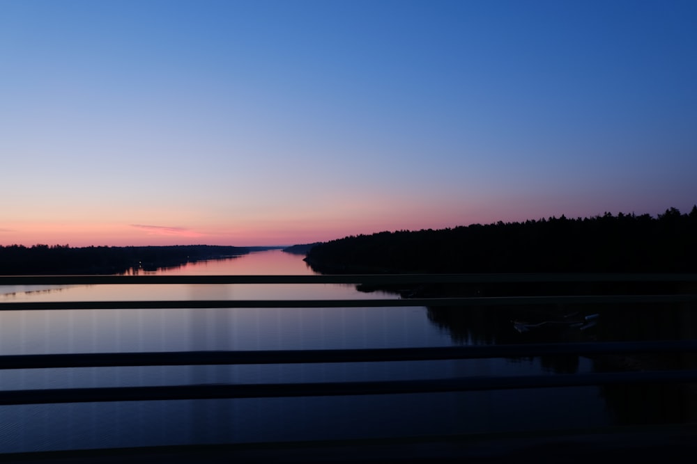 a body of water with trees in the background